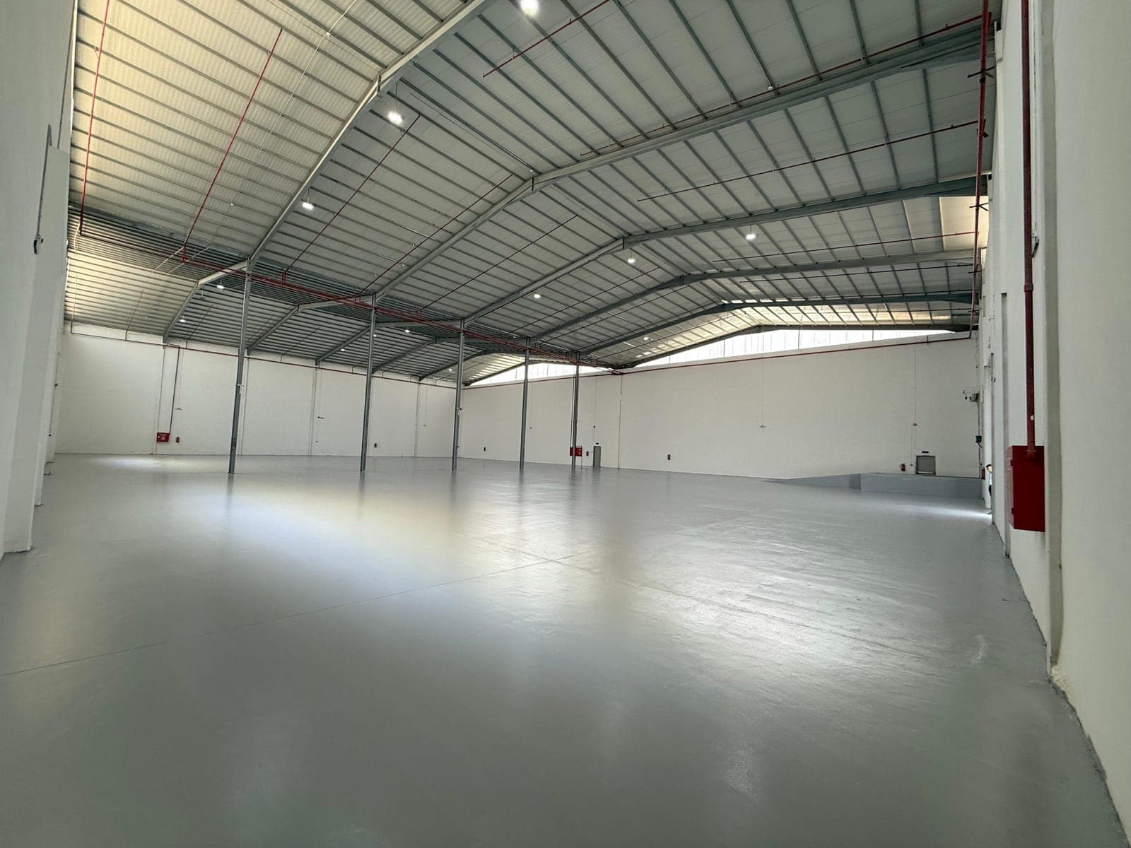 Empty storage space with an epoxy floor and good lighting